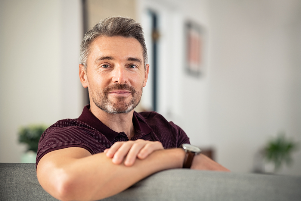 mature man relaxing on couch at home